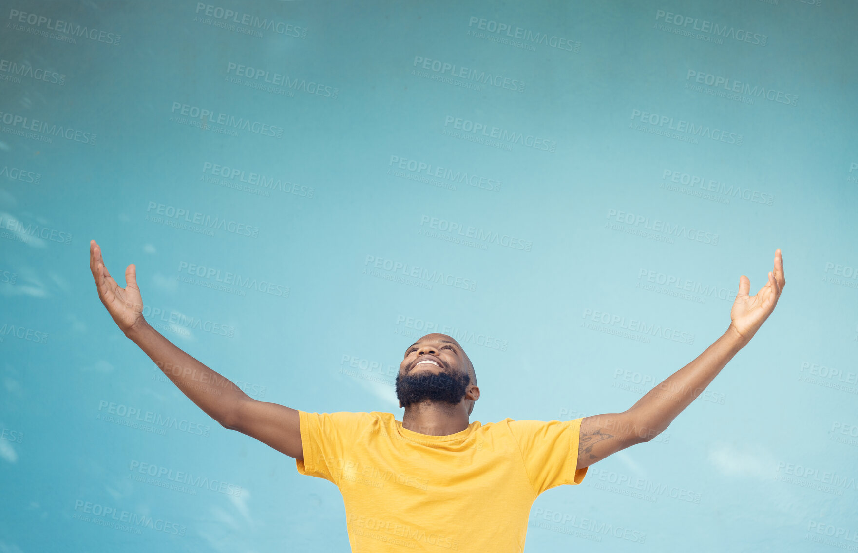 Buy stock photo Studio space, advertising and open arms of black man for announcement, news and information on blue background. Marketing, mockup and excited male for promotion, product placement and discount deal