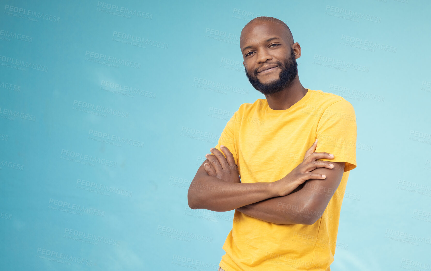 Buy stock photo Black man, portrait smile and arms crossed on mockup for advertising or marketing casual fashion. Happy African American male standing in confidence smiling for profile on a blue studio background