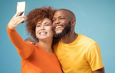 Buy stock photo Couple, hug or bonding selfie on blue background, isolated mockup or wall mock up for social media. Smile, happy or black man and afro woman on photography technology for interracial profile picture