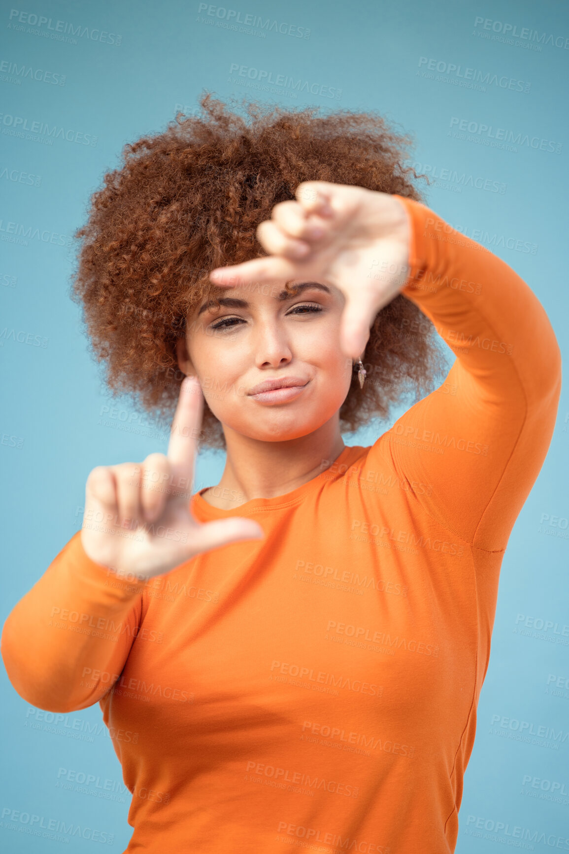 Buy stock photo Hands, frame and portrait of black woman on blue background for profile picture. Face, female and finger framing for perspective, selfie and vision of aesthetic focus, idea and photography in studio