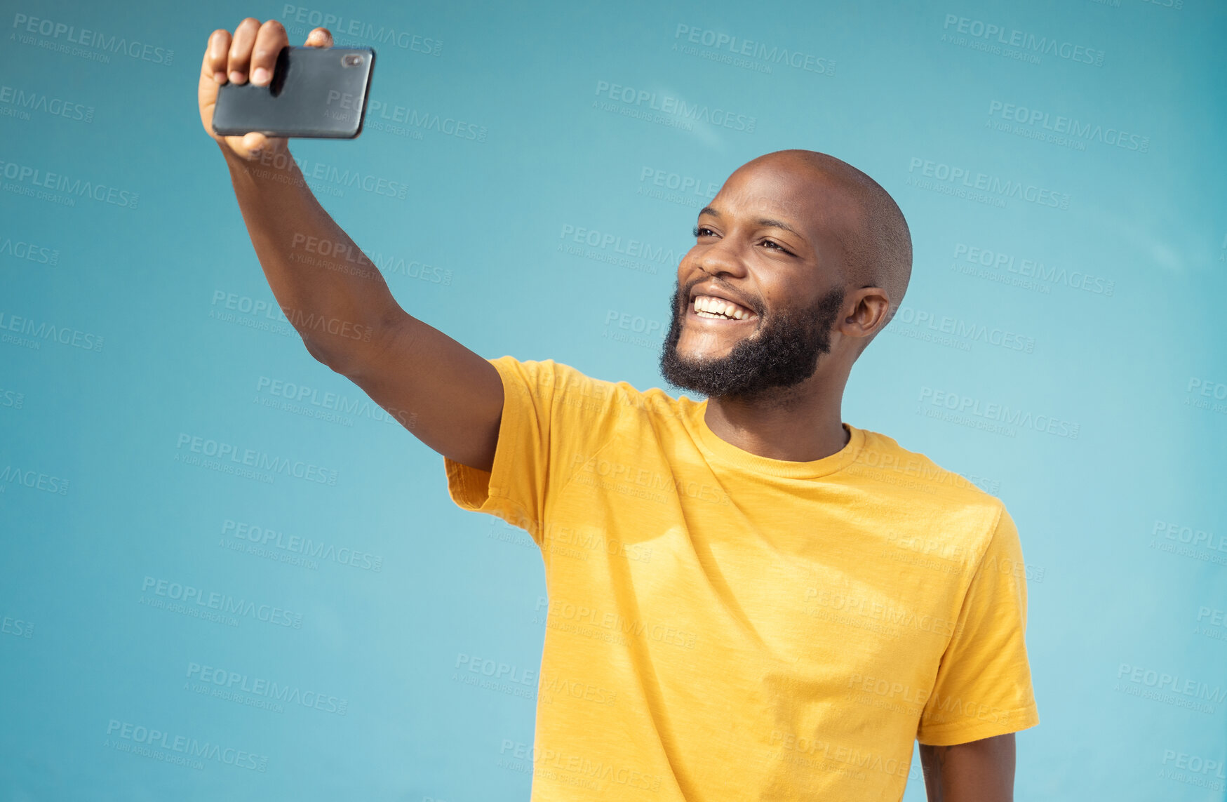 Buy stock photo Black man, happy or selfie on blue background, isolated mock up or wall mockup for social media app or vlogging. Smile, blogger or influencer on tech photography for live streaming or profile picture