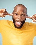 Comic, playful and portrait of a black man with a funny face isolated on a blue background in studio. Crazy, comedy and silly African person with tongue out for expression, goofy and playing