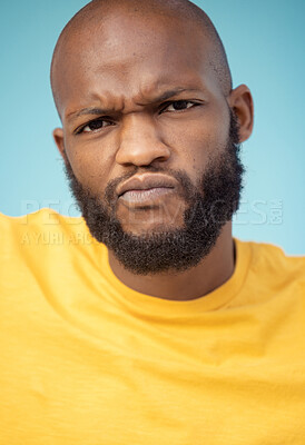 Buy stock photo Portrait, doubt and expression with a black man in studio on a blue background feeling annoyed or frustrated. Face, confused and frown with a handsome young male indoor looking upset or unhappy