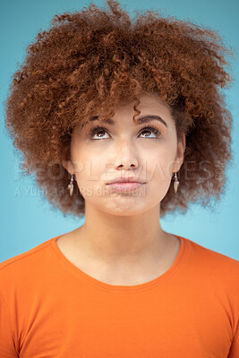 Buy stock photo Comic, thinking and face of woman on blue background with ideas, vision and looking up in studio. Fashion mockup, thoughtful and emoji facial expression of confused girl with attitude and mindset