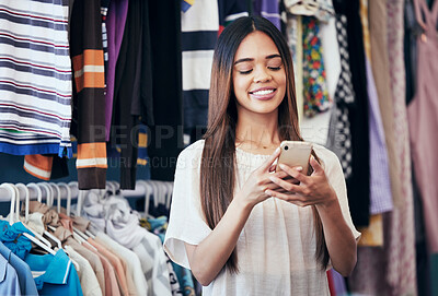 Buy stock photo Phone, clothing store and happy woman typing a message or text online or a mobile app for shopping. Happiness, smile and female networking on social media with a cellphone in a retail fashion shop.