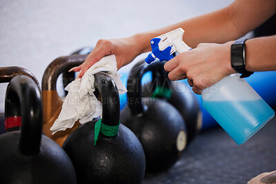 Buy stock photo Gym, hygiene and hands cleaning kettlebell with cloth and spray bottle, dirt and germs at fitness studio. Janitor, cleaner or caretaker at sports club washing dust and bacteria from workout equipment