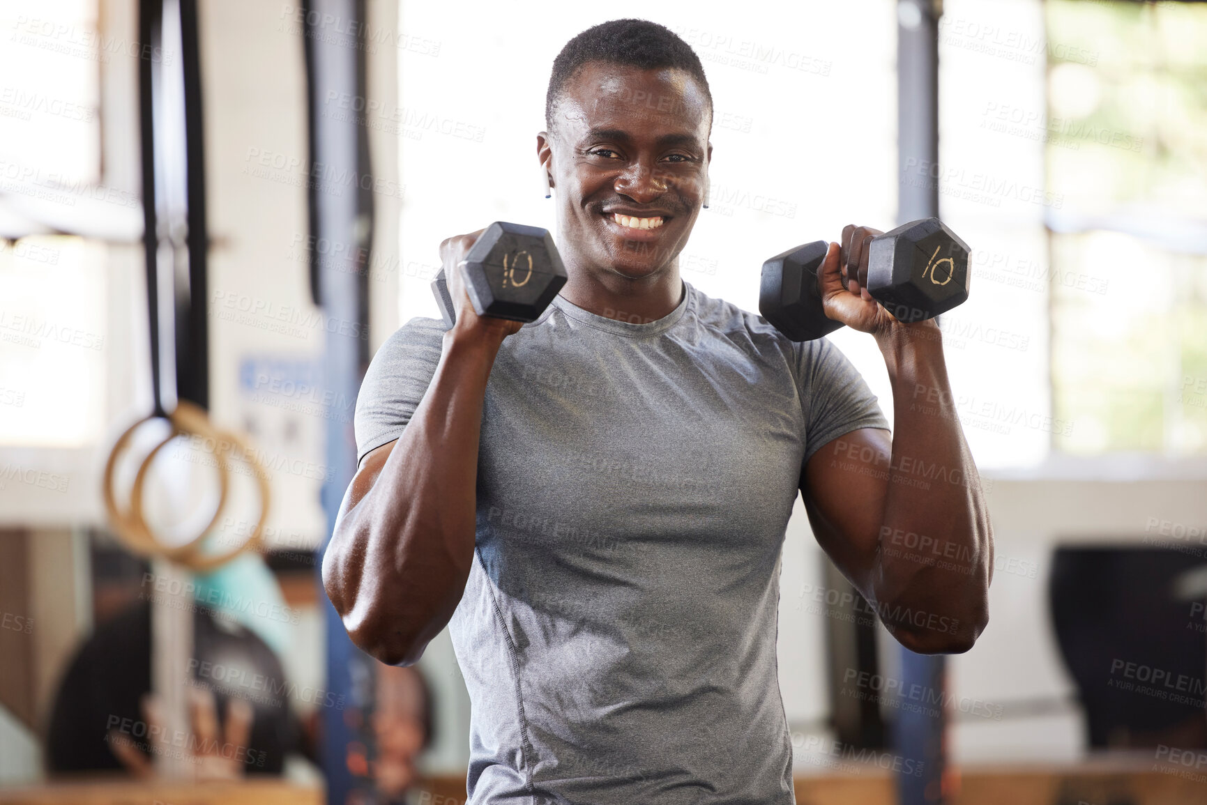 Buy stock photo Fitness, weights and portrait of a black man lifting for muscle, training and power in the gym. Smile, strong and African athlete doing a workout, exercise or sports for body building and cardio