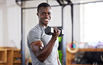 Strong, weight and portrait of a black man lifting for muscle, training and power in the gym. Smile, fitness and African athlete doing a workout, exercise or sports for body building and cardio