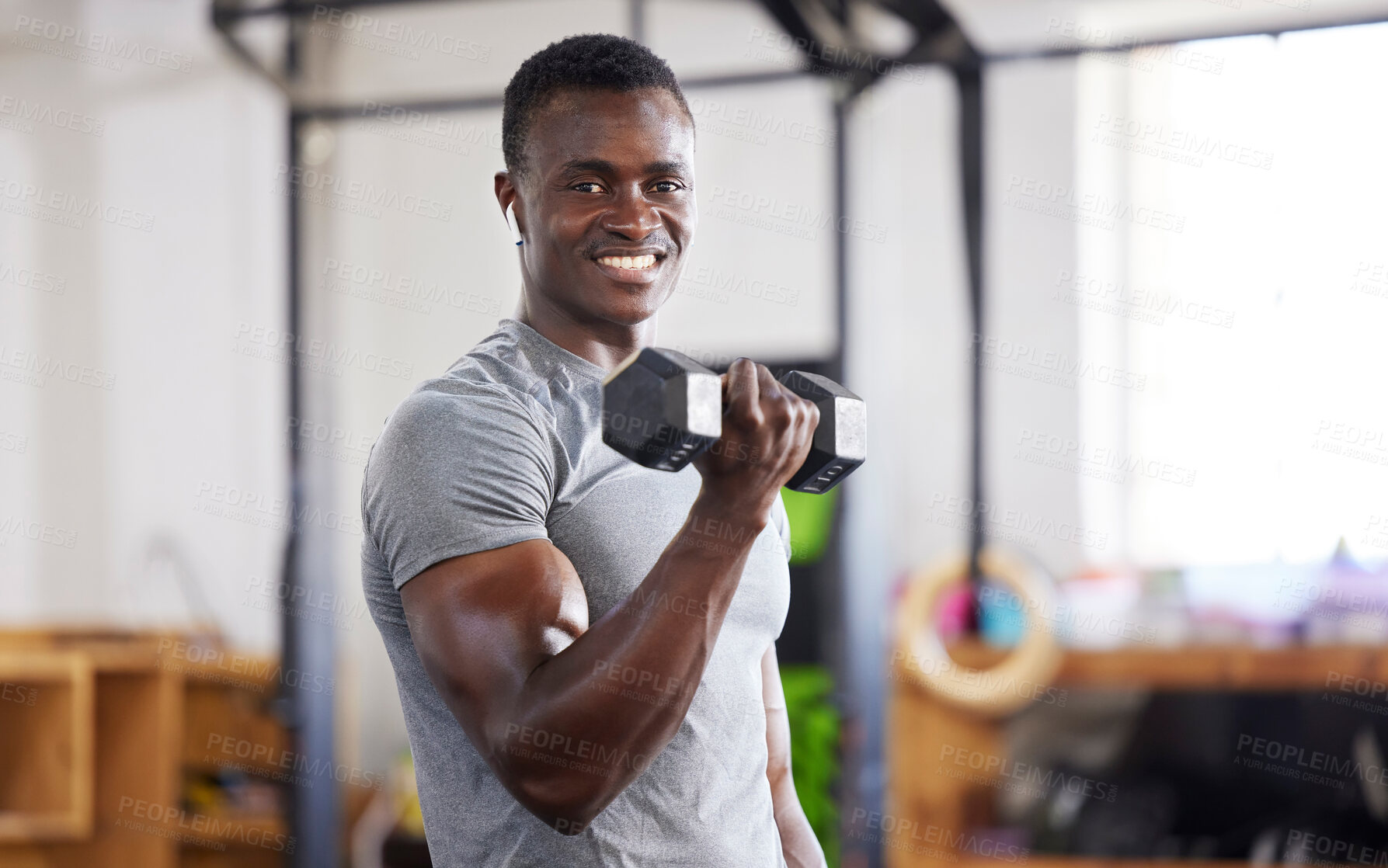 Buy stock photo Strong, weight and portrait of a black man lifting for muscle, training and power in the gym. Smile, fitness and African athlete doing a workout, exercise or sports for body building and cardio