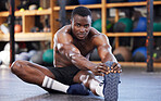 Stretching, training and portrait of black man in gym for sports, workout and performance. Wellness, exercise and fitness with athlete and warm up legs on floor for cardio, endurance and energy