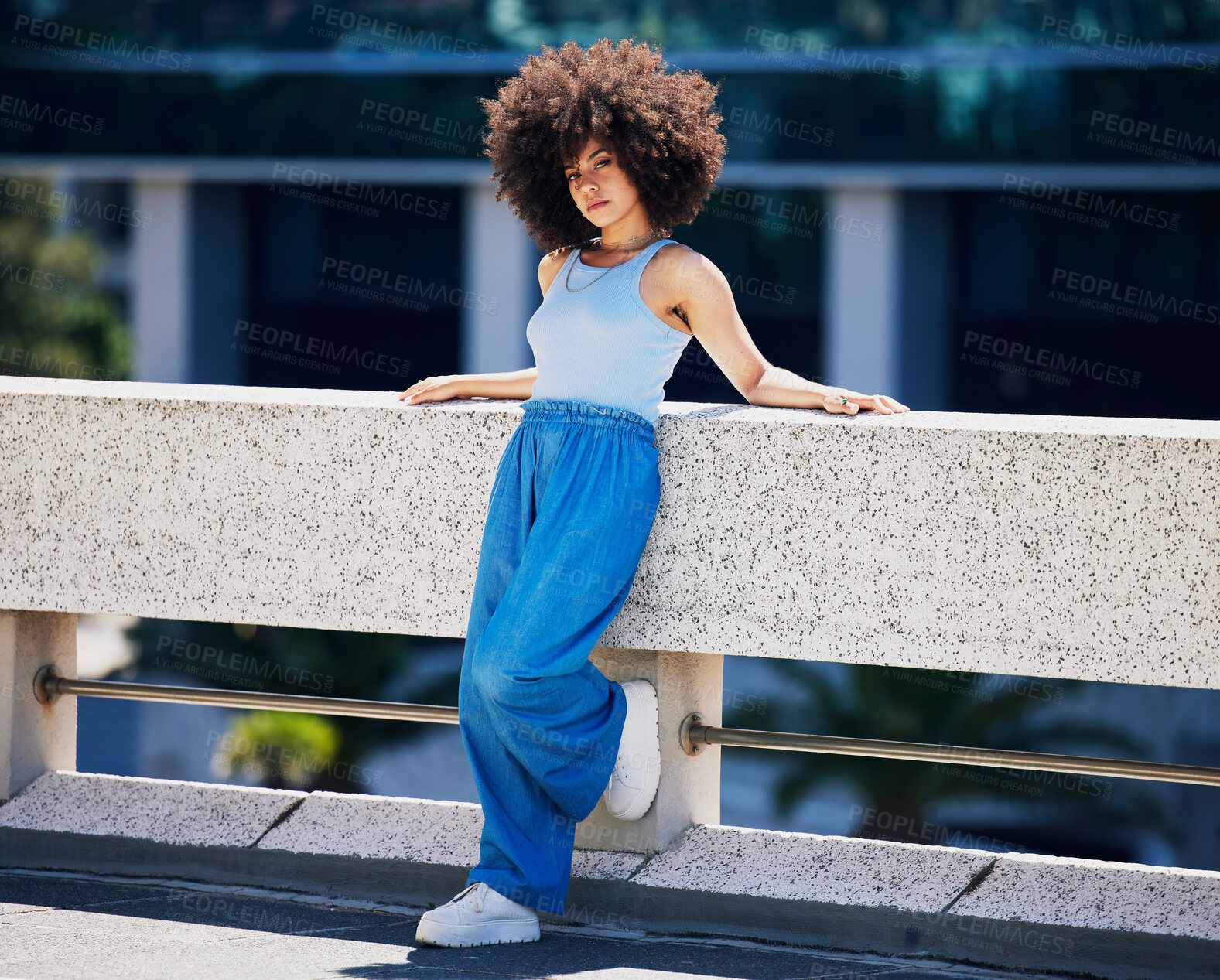 Buy stock photo Portrait, fashion and serious with a black woman in the city on a bridge, looking relaxed during summer. Street, style or urban and an attractive young female posing outside with an afro hairstyle