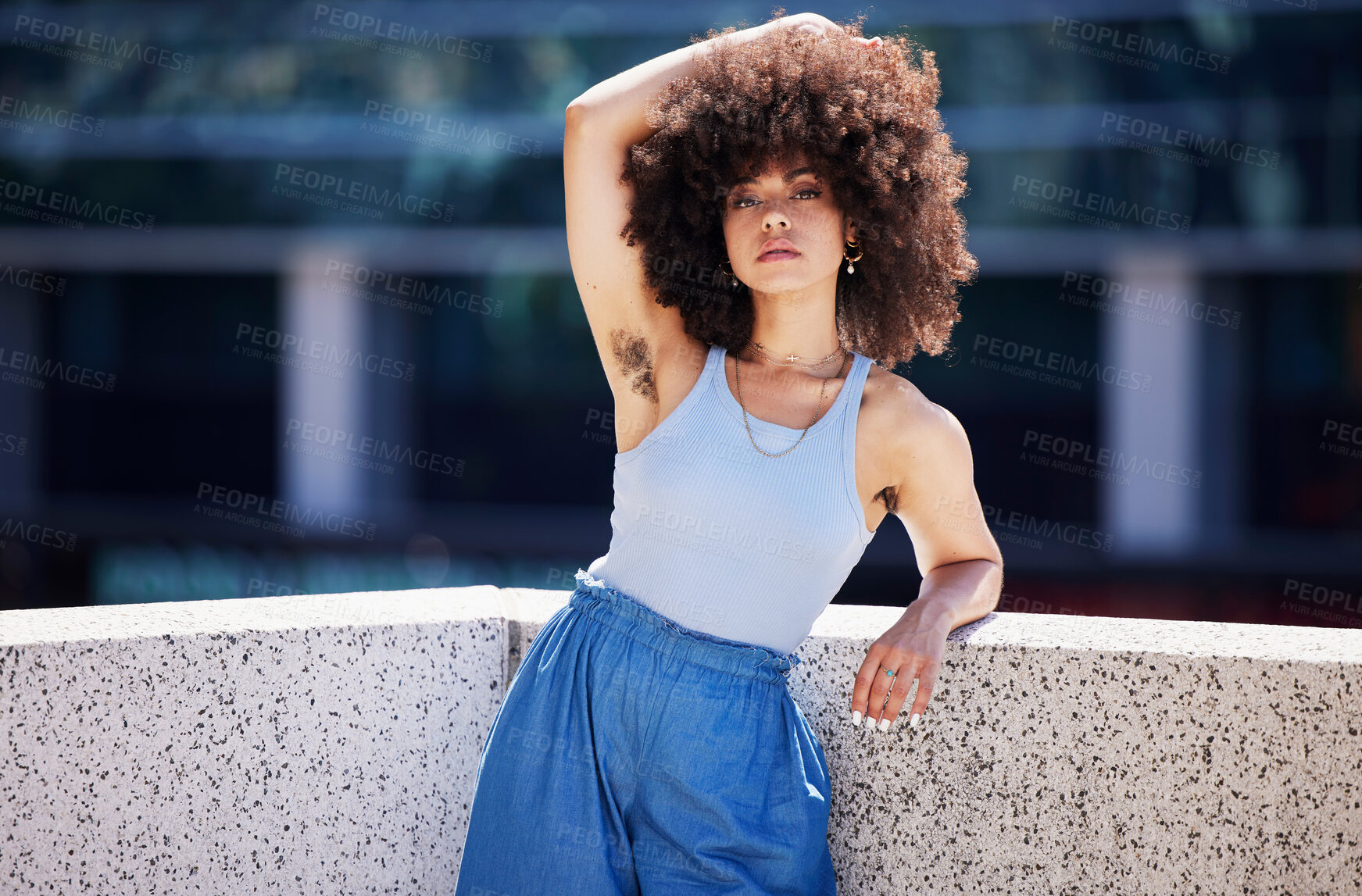 Buy stock photo Portrait, fashion and armpit hair with a black woman in the city on a bridge, looking relaxed during summer. Street, style or urban and a natural young female feminist outside with an afro hairstyle