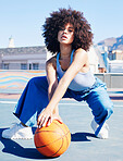 Portrait, fashion and basketball with a black woman outdoor on a sports court for urban or street style. City, fitness or style and an attractive young female posing outside with a ball for lifestyle