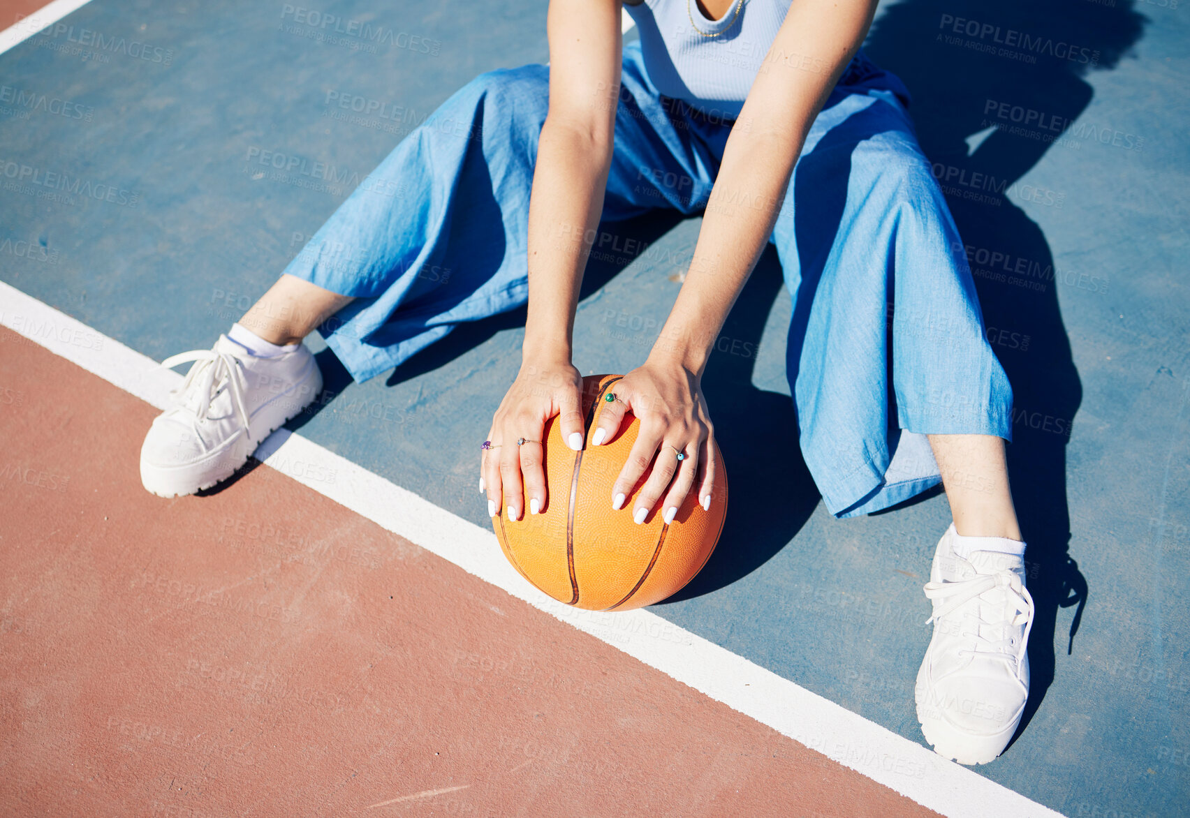 Buy stock photo Basketball, hands and woman on the outdoor court floor with urban fashion for influencer beauty. Sport, model and young person sitting with gen z clothes with sports game equipment in summer 