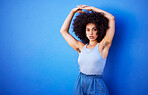 Body positivity, empowerment and portrait of a woman with hair isolated on a blue background. Beauty, natural and African girl showing armpit with confidence, feminism and attractive on a backdrop