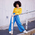 Black woman, portrait and urban fashion in the city for stylish or colorful clothing with afro hair style. African American female fashionable model posing on pavement with funky clothes in a town