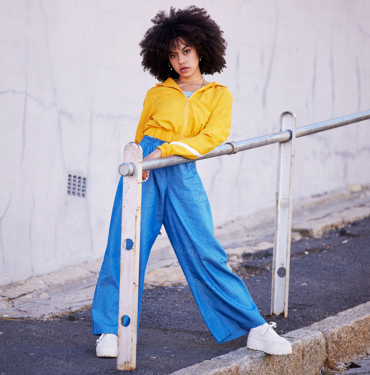 Buy stock photo Black woman, portrait and urban fashion in the city for stylish or colorful clothing with afro hair style. African American female fashionable model posing on pavement with funky clothes in a town