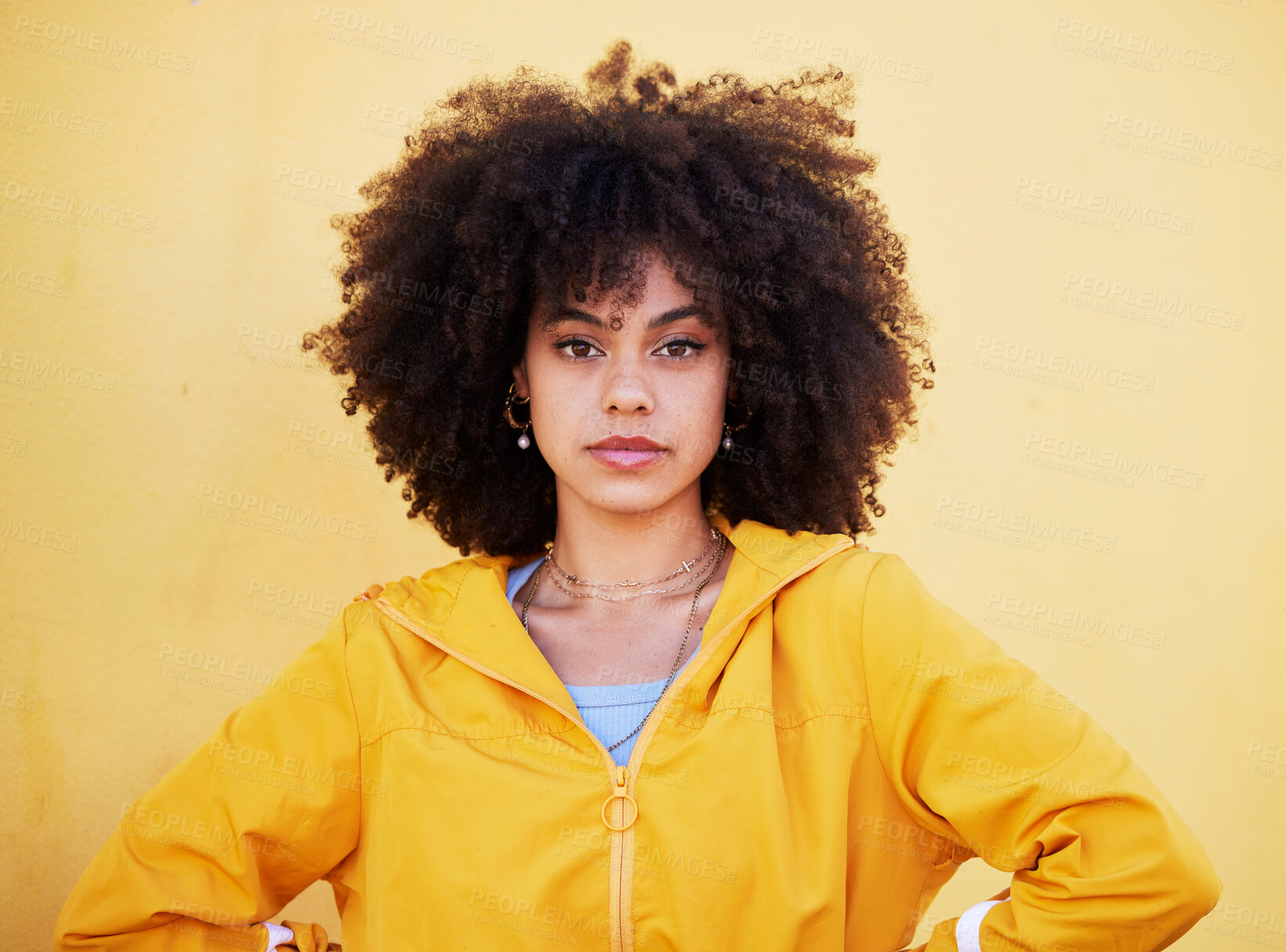 Buy stock photo Portrait, fashion and attitude with an afro black woman in studio on a yellow background for style. Trendy, hair and serious with an attractive young female posing alone on product placement space