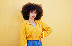 Portrait, fashion and mock up with an afro black woman in studio on a yellow background for style. Trendy, style and mockup with an attractive young female posing alone on product placement space