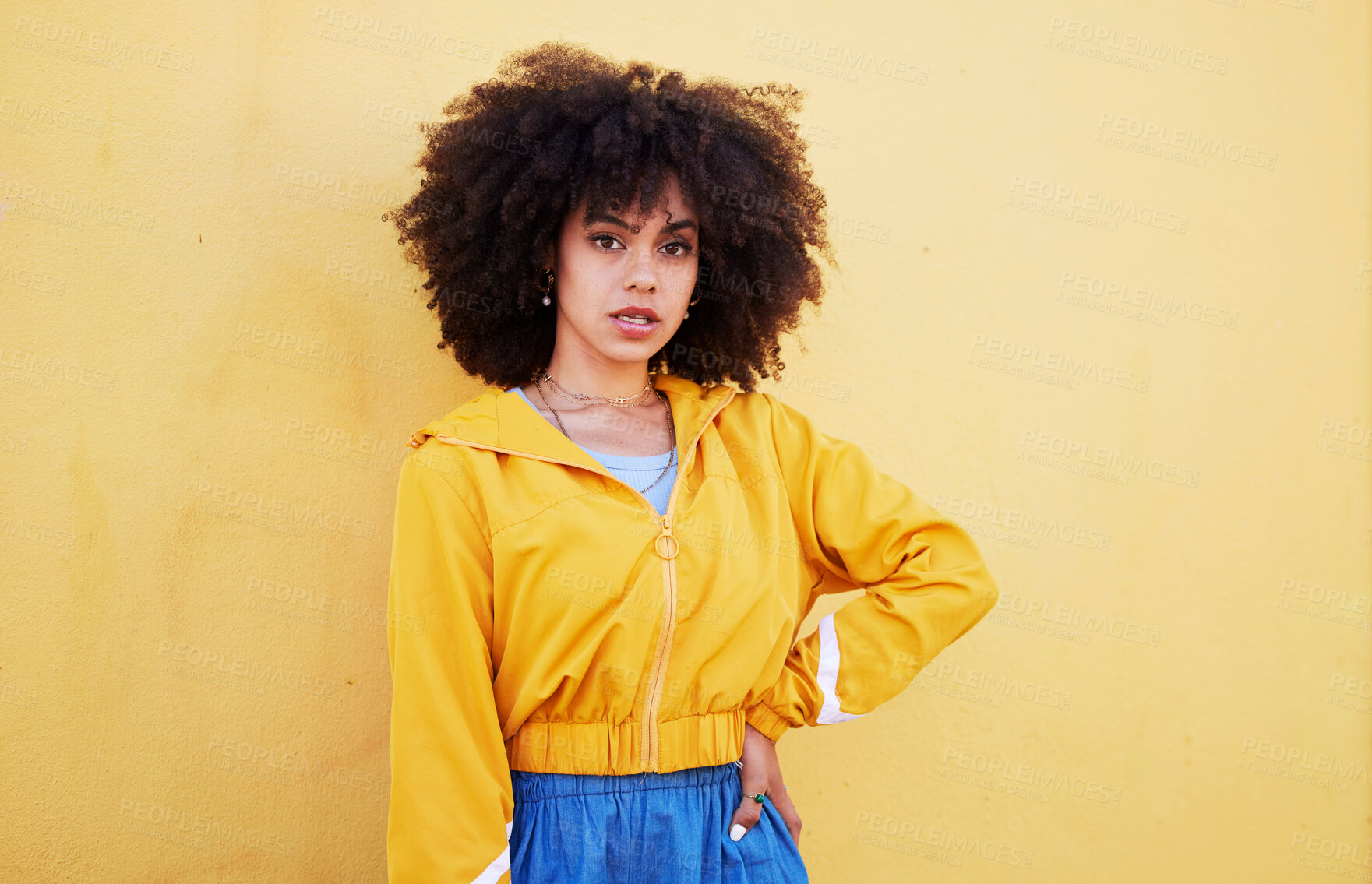Buy stock photo Portrait, fashion and mock up with an afro black woman in studio on a yellow background for style. Trendy, hair and mockup with an attractive young female posing alone on product placement space