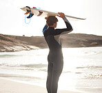 Surfer on beach, sun and man with surfboard on head, looking at ocean view with travel and nature mockup. Adventure, surfing at sunrise and outdoor with athlete, extreme sport and active lifestyle