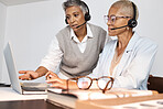 Call center, customer support and manager training a consultant by doing a consultation together online. Crm, sales and professional senior leader helping a female agent on a laptop in the office.