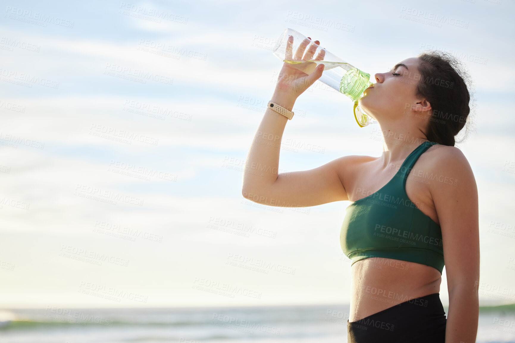 Buy stock photo Drinking water, fitness and woman on beach for running, exercise or outdoor workout nutrition, health and wellness.  Liquid bottle for diet, goals and tired sports runner, athlete or person by sea