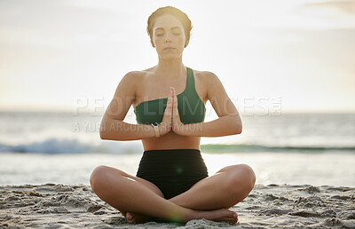 Buy stock photo Woman, yoga and meditation on the beach in sunset for spiritual wellness, zen or workout in the outdoors. Female yogi relaxing and meditating for calm, peaceful mind or awareness by the ocean coast