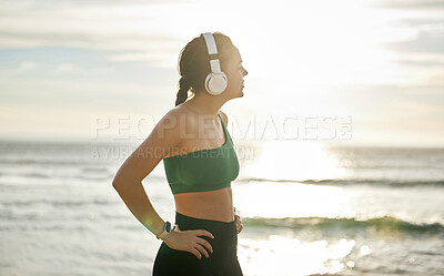 Buy stock photo Sunshine headphones and woman on beach, fitness and streaming music for peace, balance or resting. Female, lady or confident athlete with headset, sunlight or seaside for running, workout or exercise