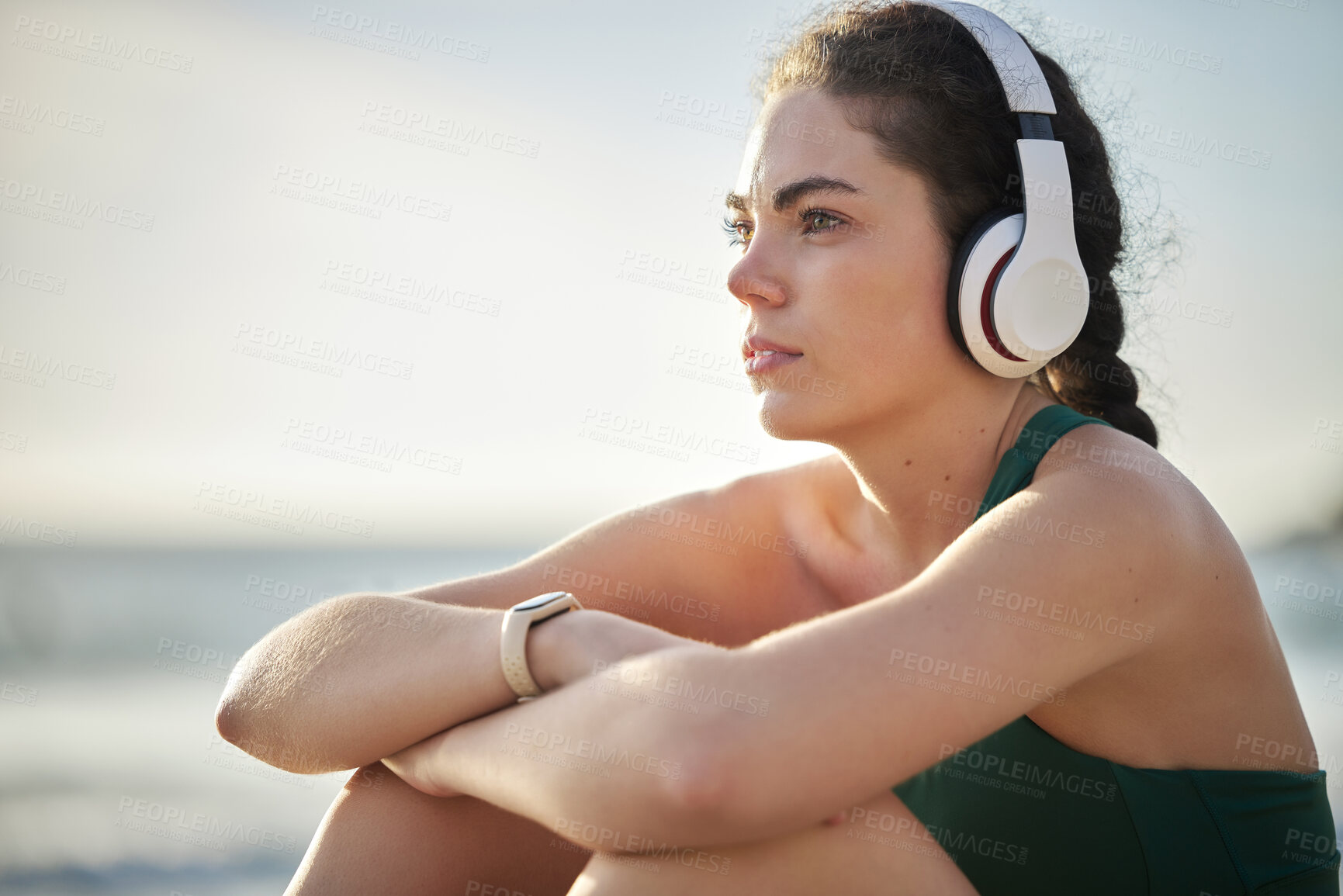 Buy stock photo Headphones, fitness and relax woman on beach for wellness, mental health and health in morning sky mockup. Thinking, ideas and calm sports person listening to music or peace podcast  by ocean or sea