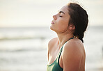 Meditate, mockup and yoga by woman at the beach, sea and ocean for calm, peace and clear mind and soul. Zen, meditation and young female relax at shore for fitness, exercise and workout