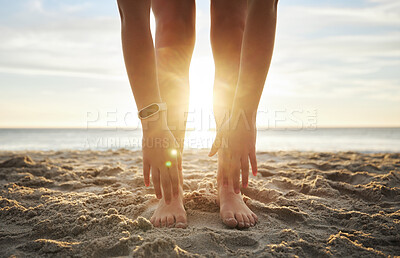Buy stock photo Stretching, fitness and feet of woman at beach for relax, wellness and yoga training. Sunset, health and peace with girl and warm up touching toes in sand for workout, energy and pilates exercise