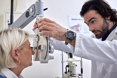 Buy stock photo Senior woman in a vision test or eye exam for eyesight by doctor, optometrist or ophthalmologist with medical aid. Mature patient in optical exam to see or check glaucoma with a helpful optician 