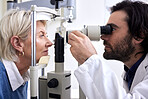 Optometry, machine exam and woman with an optometrist for a vision check, eye consultation and test. Healthcare, help and male optician with a senior patient to measure visual eyesight with equipment
