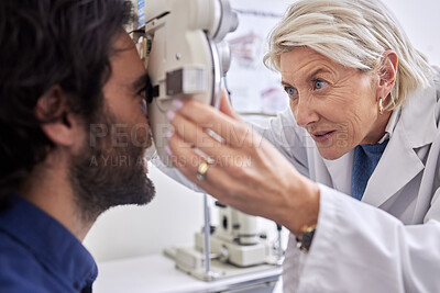 Buy stock photo Doctor with a man in vision test or eye exam for eyesight by a focused senior optometrist or ophthalmologist. Optician helping check retina health of a client or happy customer with medical insurance