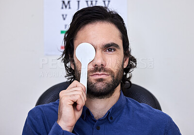 Buy stock photo Portrait, vision and spoon with a man patient at the optometrist for an eye exam testing his depth perception. Healthcare, medical and insurance with a male sitting in the office of an optician