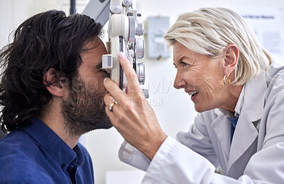 Buy stock photo Doctor with a customer in vision test or eye exam for eyesight by a senior optometrist or ophthalmologist. Happy optician helping check retina health of patient, man or client with medical insurance