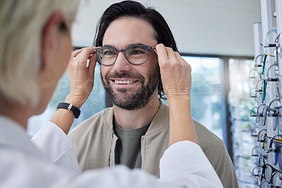 Buy stock photo Optician, glasses and happy man in store for vision, eyesight and choice of frames. Customer face, optometrist and lenses for eye care test, healthcare consulting or retail shop services for wellness