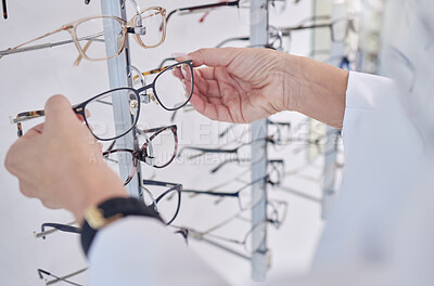 Buy stock photo Working, decision and hands of an optometrist with glasses, eyewear and frame for vision in a shop. Healthcare, retail and optician with a choice of eyeglasses for visual service and optics in store