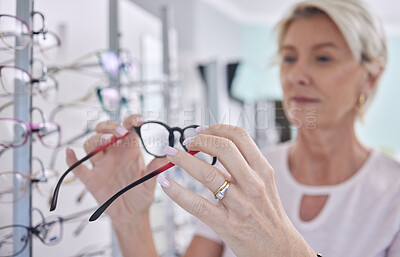 Buy stock photo Senior woman, glasses and shopping for lens or frame for eye care, vision and wellness with optometry. Customer person making choice or decision for retail sale with health insurance at optics store
