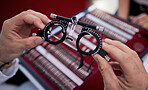 Optometry, eyewear and lens for a optical test with a optometrist in a ophthalmology clinic or store. Optic, glasses and trial prescription spectacles for eye care, health and vision at a shop.