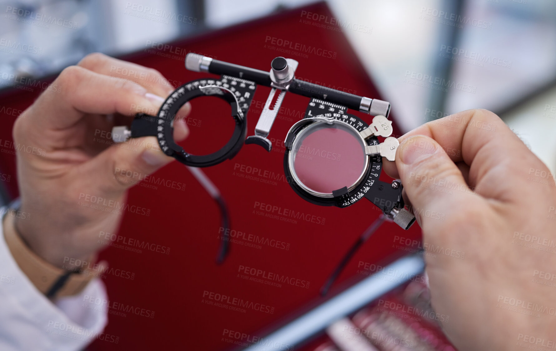 Buy stock photo Optometry, healthcare and optometrist with trial lens for a eye test in a optical clinic. Vision, eyecare and hands with a prescription optic instrument or glasses for a exam in a ophthalmology store