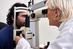 Patient, eye exam or test for vision with laser lens and doctor at optometry consultation. Man and woman healthcare person with machine for eyes, wellness and health insurance with expert care