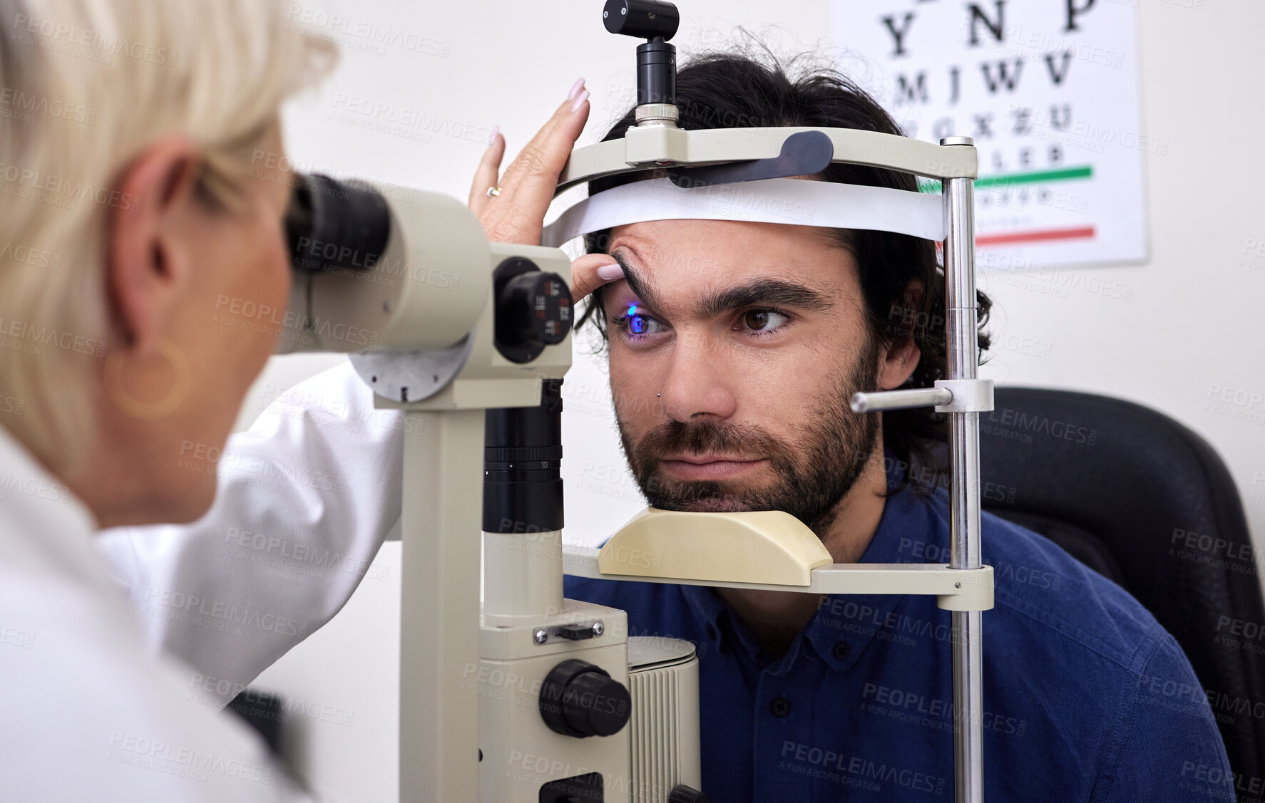 Buy stock photo Patient man, eye exam or test for vision with laser lens and doctor at optometry consultation. Person and woman healthcare person with machine for eyes, wellness and health insurance with expert care