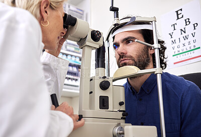 Buy stock photo Eye exam, vision test and patient with laser lens and doctor at optometry consultation. Face of a man and woman healthcare person with machine for eyes, wellness and health insurance with expert care
