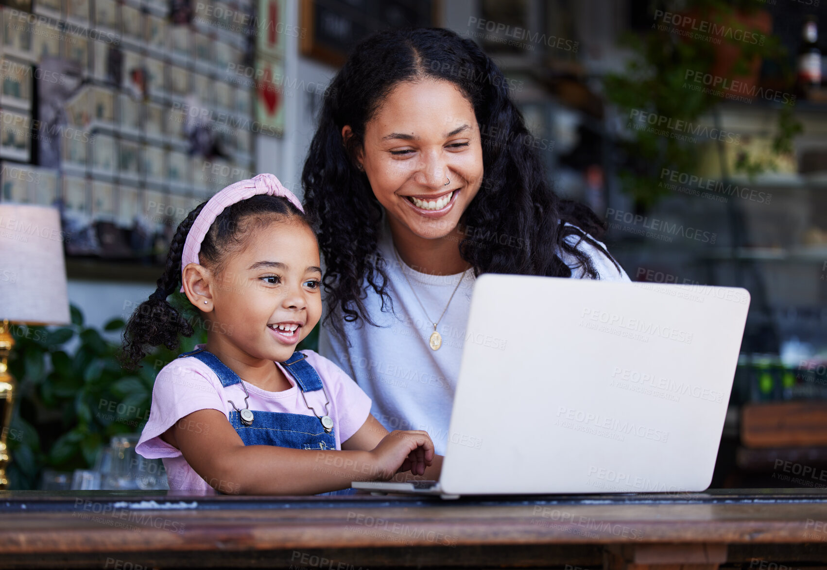 Buy stock photo Girl, learning and mother with laptop at cafe for education and development online. Family care, remote worker or happy woman teaching kid how to type on computer at restaurant, bonding or having fun