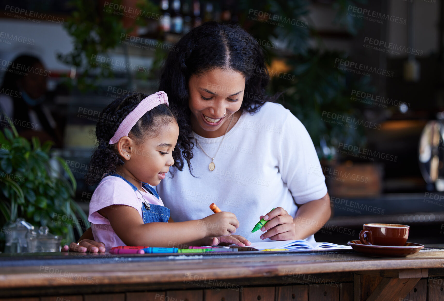 Buy stock photo Learning, drawing and mother with girl at cafe with books, studying and art education. Family, love and mama teaching kid how to color with crayons, having fun and bonding together in restaurant shop