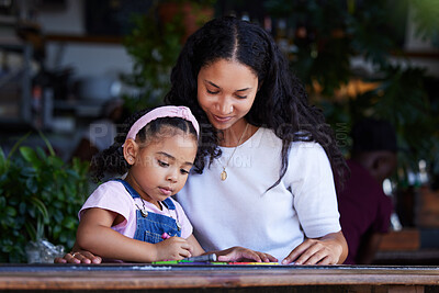 Buy stock photo Drawing, learning and mother with girl at cafe, studying and art education at table. Family care, love and mama teaching kid how to color with crayons, having fun and bonding together in restaurant.