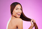 Beauty, hair and happy woman isolated on purple background for healthy glow, shine and care in studio. Young gen z model, youth or black person in portrait for natural growth, color and salon mockup