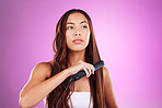 Hair, flat iron and face of girl on purple background for wellness, cosmetics and beauty treatment. Salon aesthetic, hairdresser and girl with heat product for healthy, shine and natural hair style